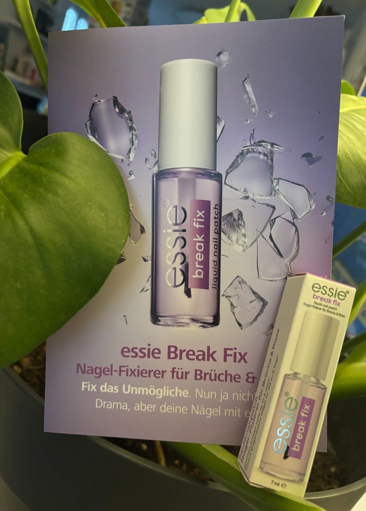 essie Break Fix Nagel Fixierer mit Verpackung vor einer grünen Zimmerpflanze